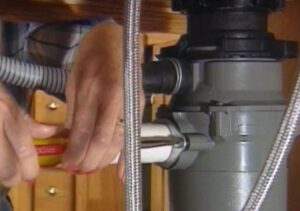 how to fix a jammed garbage disposal video